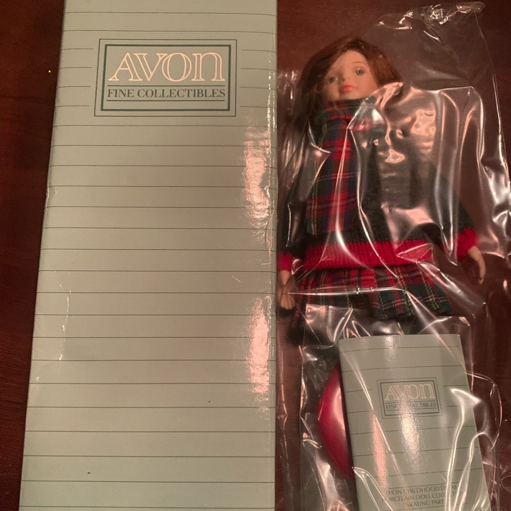 Christmas porcelain doll . Avon collectible doll brand new in box.